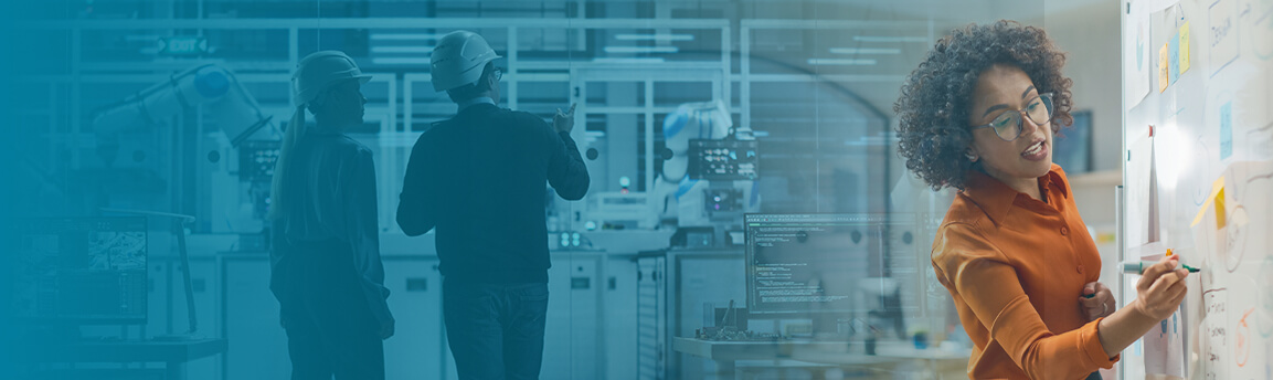 Woman at whiteboard in front of factory workers