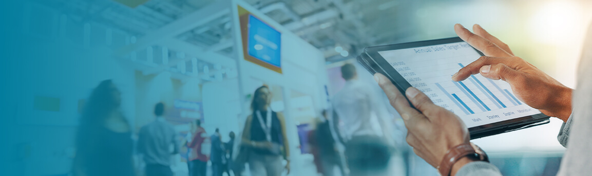 Someone using an tablet in front of a trade show
