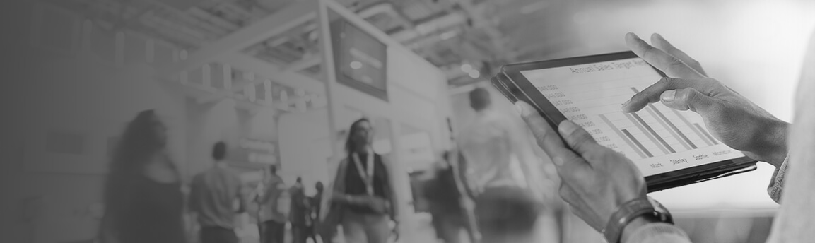 Someone using an tablet in front of a trade show